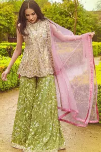 Wear this soft and supple hues richly decorated by shade pink with zardozi embroidered motifs and floral bootis all over the shirt. The outfit is finished by beautiful overlaping and scalloped hemline. It comes with an exquisite sharara with embroidered border and floral bootis all over to give it a regal look. The outfit is coordinated with pink net dupatta having sequins spray all over the ground and zardozi embellished borders along the length.