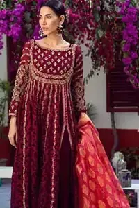 The perfect combination of tradition and class. With a lot of attention to detail, the intricate zardozi work with using glass beading and threads makes the bodice look like nothing but a dream. The tiny floral motifs are also scattered on the bodice. This mehndi outfit is ornamented with vertical embroidered lines and coral applique at the bottom. It comprises with maroon capri pants and coral self fabric dupattta. You are all set to make a lasting impact with the divine royalty of this dress.