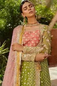 We have brought a charismatic charm to the traditional motifs and cuts. Our embroidery is rich in detailed traditional techniques executed to perfection. The bride shines bright in this outfit, embedded with sophisticated zardozi and thread embeishments. The bodice and hemline is furthermore emphasized with intricate details that gives the perfect ending to this mehndi dress. Pair it up with yellow sharara with captivating embellished border. The dupatta incorporates beautifully designed borders with zardozi, applique and kiran along the length, focusing on the geometrically embellished pallu and sequins spray all over to give it a perfect look.