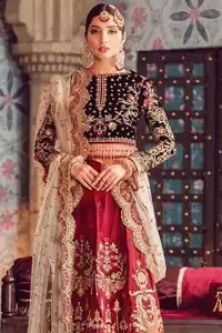 The new season is all about making a statement. Captured in traditional silhouette, The bridal stands out due to its uniqueness and the perfect fusion of modern cut and traditional embroidery. Black velvet blouse is beautifully decorated with multiple colour embroidery and finished with tassels. It comes with full embellished velvet lehenga adorned with applique all around the edges and motifs all over it. This outfit is coordinated with beige net dupatta which is sprinkled with sequins all over it. It is further furnished with a four-sided scalloped border.