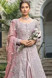 Intricate details, flamboyant silhouettes and mastery of colour are what makes this dress stand out from the rest. This is one of the elegant pieces that are sure to stay in your heart. Unique craftsmanship and detailed embellishments bring heavenly hued gossamer fabrics to life. The gown is beautifully sculptured with floral embroidery, adorned with intricately embellished borders with silver kora, Dabka, pearl and sequins work all over. Pair it up with a pink inner maxi and ruffled sharara gives the perfect ending to the outfit. The dupatta incorporates beautifully designed borders on all four sides, focusing on the heavily embellished pallu borders to give it a perfect maharani look.