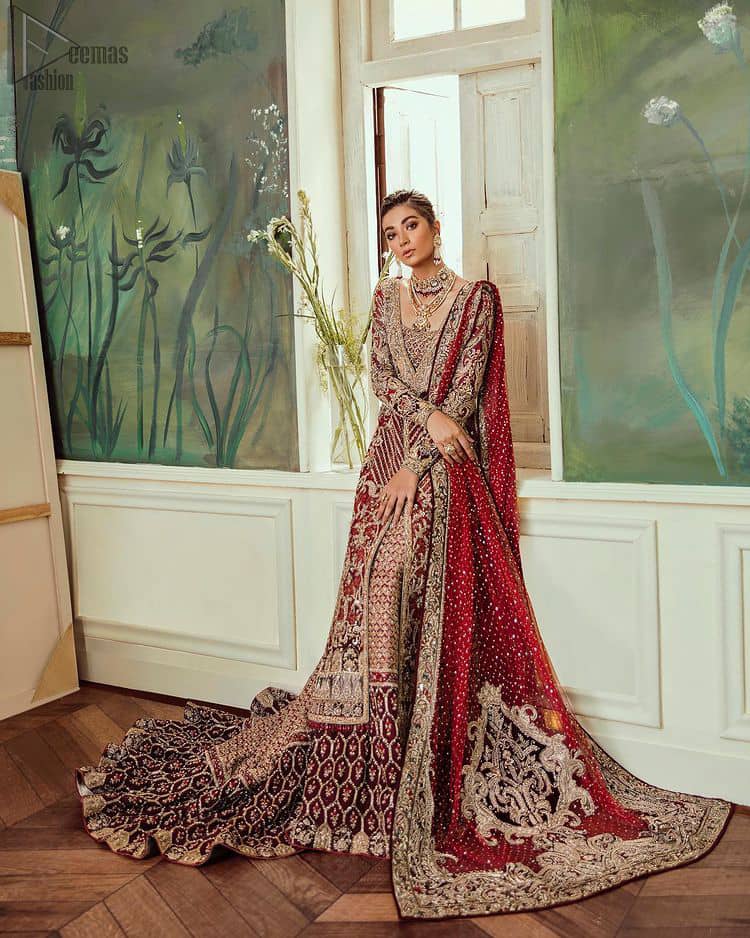 Deep red jacket gown having inner velvet blouse with maroon back train lehenga and heavily embroidered dupatta.