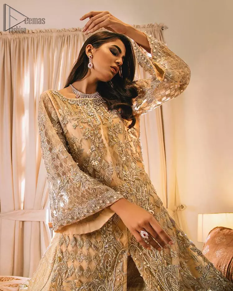 An unforgettable look and ideal for the festive season. An elegant yet trendy front open style makes this outfit more classy. Crafted artfully with detailed zardozi work and illusion neckline finessed with kora, dabka, and Kundan. The motifs and intricate details are a true example of decorative and ornamental expression stylized in a contemporary way. The bell sleeves make this outfit more classy. Balance the look with banarsi lehenga highlighted with embroidered borders at the bottom. The dupatta is enhanced with embroidered pallu.