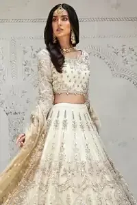 Designed with great expertise, the Ivory Blouse Lehenga is going to set you on a heavenly journey, full of comfort, merriment and unlimited beauty. In a professional sense of full sleeves, the dress is laudable for its majestic light golden and silver embroidery under the very meritorious round neckline. To contribute towards its eminence, this bridal wear is made with the finest organza. A lehenga and an exquisite net dupatta make this marvelous attire a paragon of extreme beauty on your Walima.