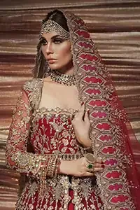 A bride wants to feel as beautiful as she is on her special day, and knowing that our Lehenga was the final decision in that, it is priceless. This bold and iconic bridal ensemble with its dainty flutter silhouette leaves us feeling whimsical, romantic, and even a bit enchanted. This front open pishwas is laden with silver and golden zardozi work, a beautifully crafted waist belt and floral embroidery patterns. The dress is even more enhanced with the ruffled bottom. It is coordinated with a beautiful dupatta with thick matha Patti borders along the length and an intricate beautiful border on the rest of the two sides.
