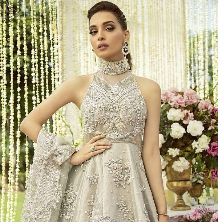 the peplum is emphasized with a delicate arrangement of hand-embellished floral bunches and scattered sequins spray all over.