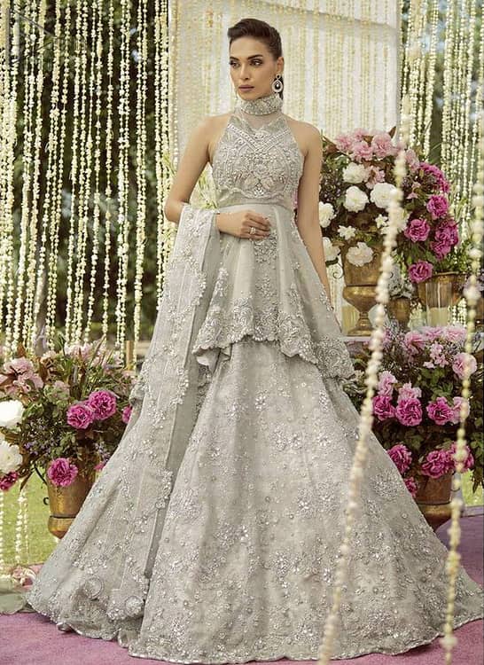 The back train peplum is adorned with a halter neckline and beautifully embellished bodice with silver zardozi work.