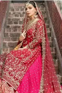 It’s ALL in the details, This breathtaking wedding dress offers comfort without compromising on style. This outfit laden with ornamental embellishments and embroidery creates such a fairytale touch to your big day. Paired with a pink sharara creates an unusual charisma wholeheartedly. Embroidery is done in the shade of golden and tiny floral motifs scattered all over the shirt. Sharara is emphasized with sequins spray and zardozi details at the bottom. Complete the look with a red dupatta having scalloped borders and scattered tiny floral motifs all over the ground.