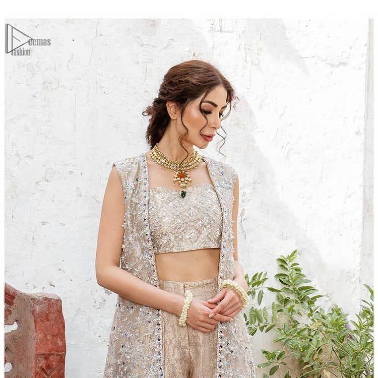 This sleeveless blouse follows an open front, lined beautifully with geometric patterns. A traditional design of mesmerizing silver embroidery intensifies its charm. Pakistani Party Dress - Beige Open Shirt n Blouse - Palazzo Pants.