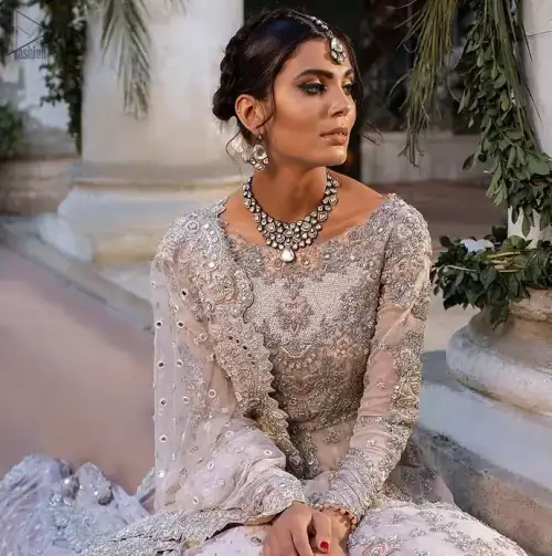 Beautiful Pakistani wedding dress in light peach front open pishwas with back train lehenga and emrboidered dupatta. This outfit brings