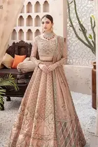 South Asian Wedding Wear Peach Blouse Lehenga. DupattaThis breathtaking fit and flare wedding dress offers comfort without compromising on style. This nude peach colour is the perfect feminine and delicate shade with its meticulously crafted fabrication with gorgeous embroideries. The multiple colour embroidery The outfit comes with an embroidered belt. Adorned with sterling sequences and silver and crystal hand embellishments, it's a classic modern masterpiece!