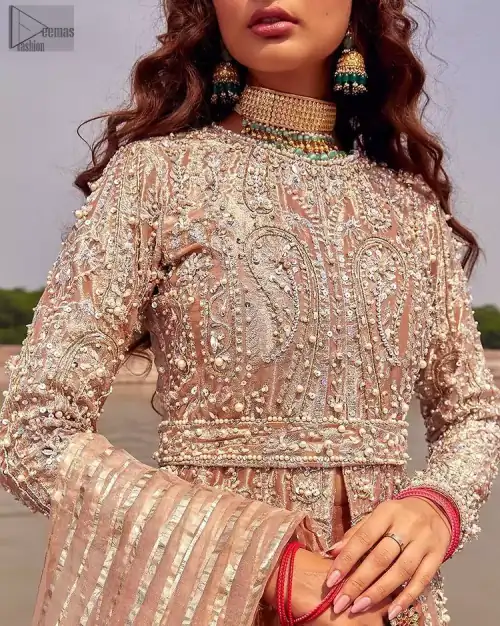 the dress with a tissue dupatta and graceful palazzo pants makes you the center of attention on your big day. Peach