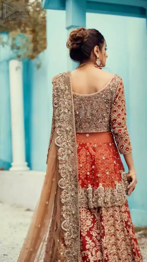 Red Peplum and Lehenga with Rust Net Dupatta. It features a highly remarkable back train and is decorated with fascinating