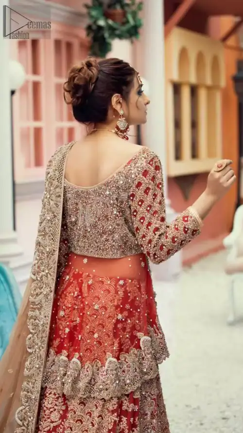 Red Peplum and Lehenga with Rust Net Dupatta. It features a highly remarkable back train and is decorated with fascinating