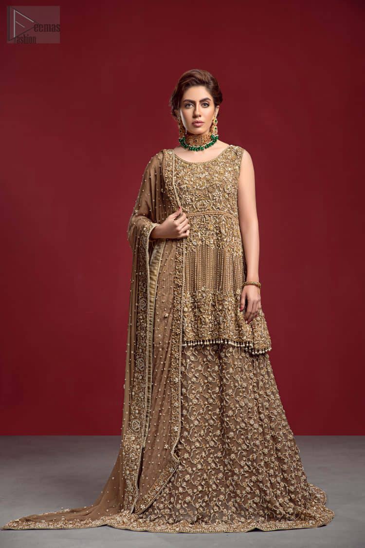 Captured in a traditional silhouette, The bridal stands out due to its uniqueness and the perfect fusion of modern cut and traditional embroidery. This dress is beautifully decorated with heavy embroidery. It is highlighted with kora, dabka, tilla, sequins and pearls. The peplum is enhanced with zardosi work all over and tassels on the hemline. It comes with a full embellished lehenga adorned with a fully embellished back train. It is coordinated with an organza dupatta which is sprinkled with pearls all over it. It is further furnished with a four-sided embroidered border.