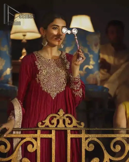 A picture of pure elegance with maroon crushed frock enhanced with embellished golden embroidered neckline. The neckline is adorned with