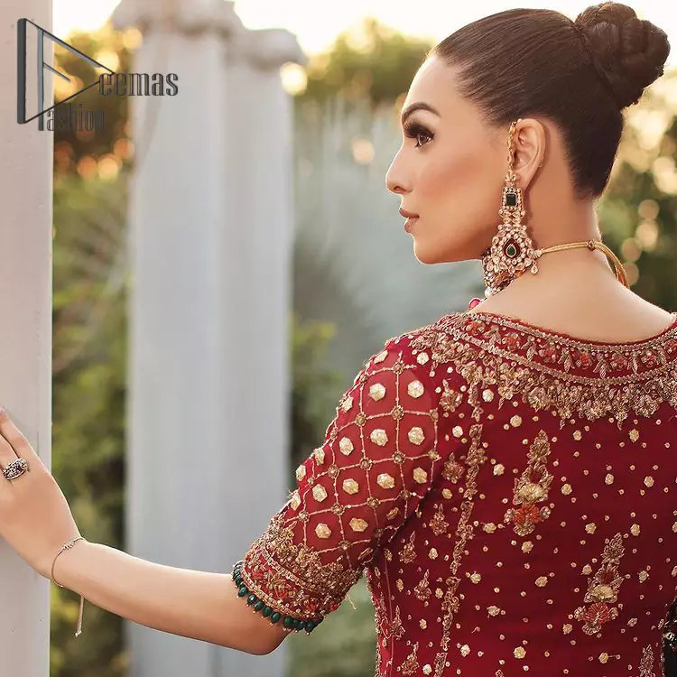 Just fulfill your love for maroon on your Big day with DeemasFashion. Giving you all the glam with this maroon scalloped front open frock which is beautifully sprinkled with golden tilla, dabka, kora, crystal, and Resham thread work. In addition to this, the square neckline and half sleeves with multicolor embroidery look so stunning and soothing on your Big day. It is attractively synchronized with cigarette pants to grant you a remarkable aesthetic focusing look.