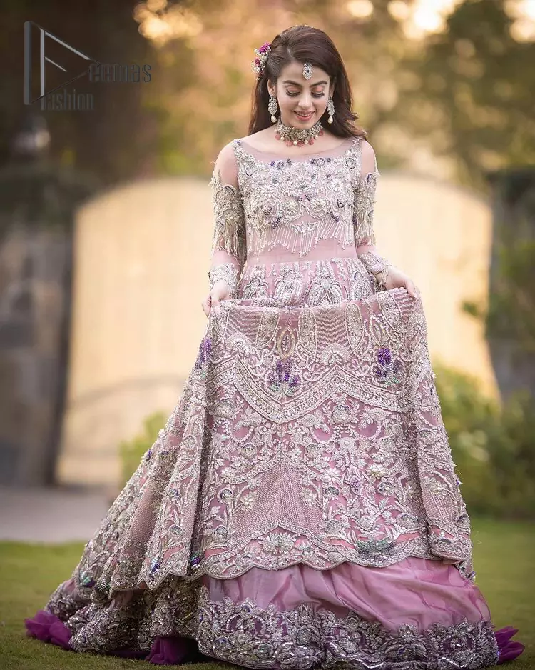 If you want to go high on the fashion charts then just go with this pink outfit of Deemas Fashion. This full sleeve pink pishwas is certainly any girl's dream that is fully embellished with multiple colour thread embroidery and silver zardozi work that includes kora, dabka, and crystal work to get so cool look. Furthermore, the boat shape neckline of this pishwas is just increasing the focus of this article. It is synchronized with the back train frilled lehenga to enhance your beauty on any occasion.