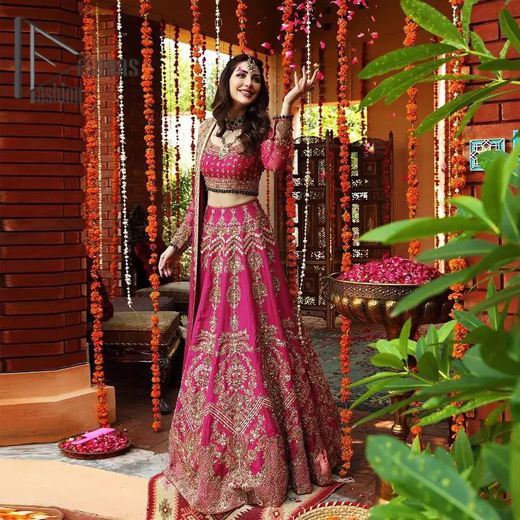 A color splash is always a floral dream. Let your energy shine with these popping Shocking Pink blouse that is ornamented with golden embroidery that involves tilla, dabka, Resham, and multi-color thread work just to magnify the display of the outfit. In addition to this, the full sleeves of the blouse when combined with a square neckline it gives a dazzling effect to the article. It is beautifully organized with can can lehenga that is also embellished with golden embroidery as well. Finalize this article with the same color dupatta that is adorned with four-sided lace and sequins spray all over just to fulfill your floral dream on your walima day.