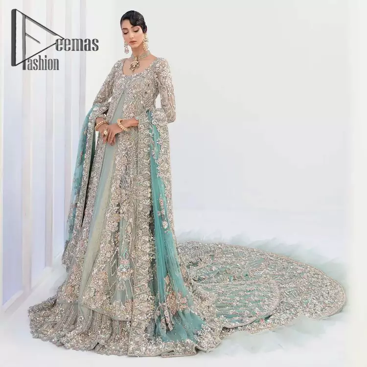 Sync. Style. Slay! A wedding is better when you get a super stylish all-in-one. DeemasFashion presents you with an ice-blue front open maxi this is decorated with silver embroidery which involves tilla, dabka, kora, and pearls work to magnify your inner pleasure on your Walima day. It is dominant with full sleeves just to grant you an aesthetic look. It is attractively coordinated with an ice blue lehenga with back train styling to give you a fairy look. Complete this outfit with the same colour dupatta that is beautifully embellished with floral motifs and a four-sided border.