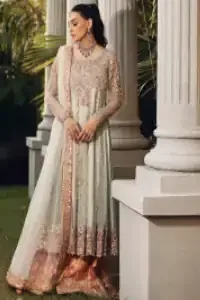 Unveiling your inner happiness is what it's all about your outfit. Just seep royalty in the texture and layers of this mint green scalloped maxi of DeemasFashion. The round neckline of the maxi is looking super aesthetic when comes with full sleeves. Further, the maxi is beautifully adorned with golden and antique embroidery that includes mainly tilla, gota, and crystal work just to give you a soothing and amazing look. Marvellously maxi is paired up with rust sharara with embroidered border to express your happiness as well. Finish this look with a mint green dupatta that is highlighted with a rust border and sequins spray all over it that seeps the royalty of the article.