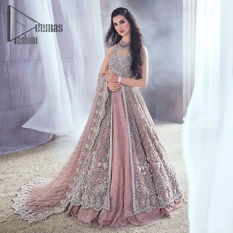Rose, glitter, and glam are the mood. Shine through with all eyes on you! A full festive package dipped in an oyster pink tone. Presenting oyster pink front open maxi for your walima day just to boost up your inner happiness. The maxi is handsomely adorned with silver embroidery that is embellished with tilla, kora, dabka, and pearls work. Furthermore, it is highlighted with full sleeves just to give you a glam and shiny look. It is systemized with an oyster pink lehenga to give you a superstar look. End up this article with the same color dupatta that is prominent with a four-sided embellished border and sequins spray all over.