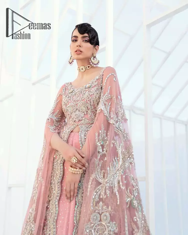 Wants regal, striking, and bold? Our tea pink maxi is all you need to bring out the queen in you. Detailing this tea pink maxi is as amazing as the front open style of maxi. Maxi is prominent with silver embroidery that involves kora, dabka, tilla, and crystal work to give you a bold and regal look on your walima day. Further, it looks super stunning when full sleeves combine with a round neckline. The maxi is coordinated with a double tone lehenga that the bottom side reflects the yellow color to give an aesthetic and stunning look. Complete this article with the same color dupatta that is embellished with a four-sided border.