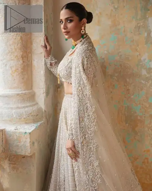 With a touch of Divine. A stunning ivory blouse is laboriously frosted with meticulously detailed hand embellishment with kora, dabka,