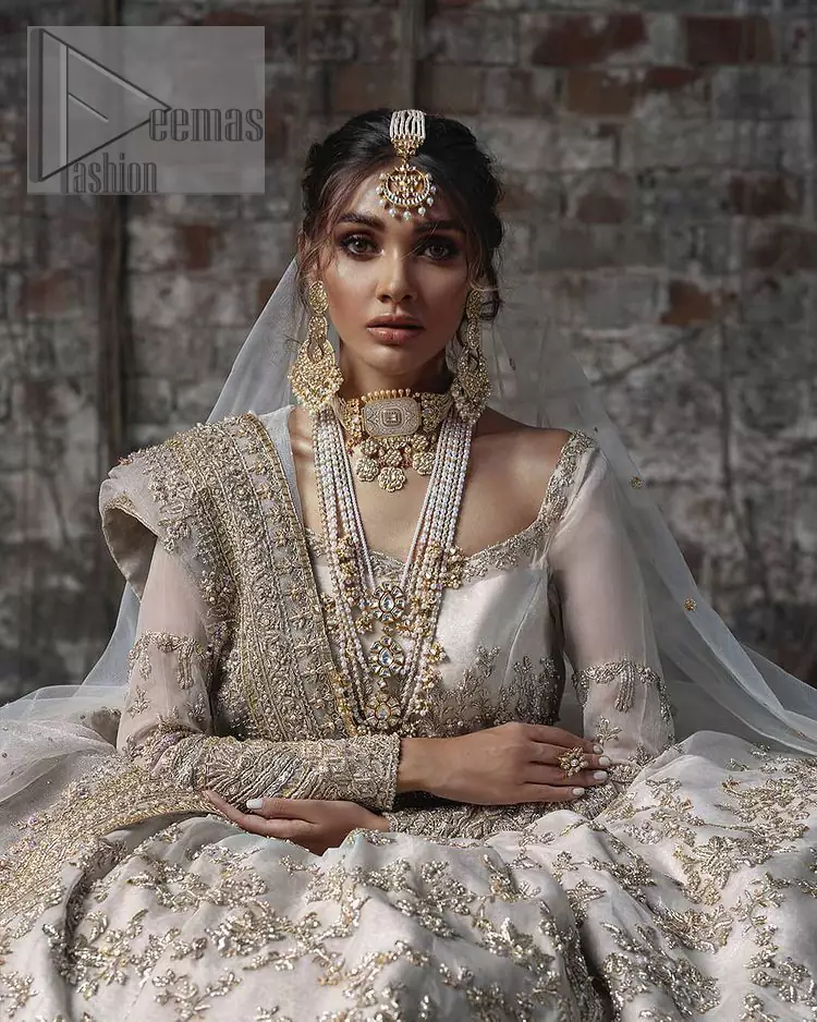 Back train is a dreamy silhouette designed to highlight you like the dazzling jewel on your walima day. The back train of ivory white maxi is beautifully embellished with silver and golden embroidery which includes kora, dabka, and sequins work. Further, it is prominent with full sleeves and boat shape neckline just to enhance the attractiveness of this ivory white maxi. It is paired up with the same colour dupatta that is adorned with a four-sided embellished border and combined with sequins spray all over just to complete your dreamy look on your Walima. 