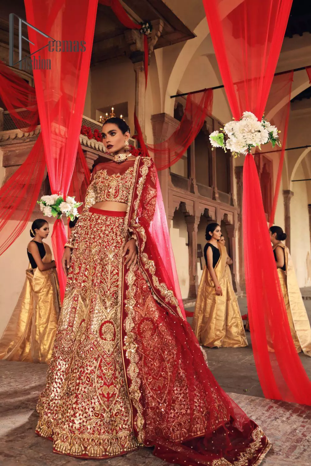 Celebrate the most romantic moments of your Big Day in the style of DeemasFashion. The red blouse represents the love in the air with handsomely embellished golden embroidery which includes kora, dabka, tilla and zardozi. It is prominent with an illusion neck and combine with full sleeves to enhance the love of you for your lovely audience. It is coordinated with a lehenga which is heavily adorned with the finest embroidery and looks super splendid as well. Complete this lovely article with the same colour dupatta that is adorned with a four-sided border and sequins sprayed all over to give you the romantic look.