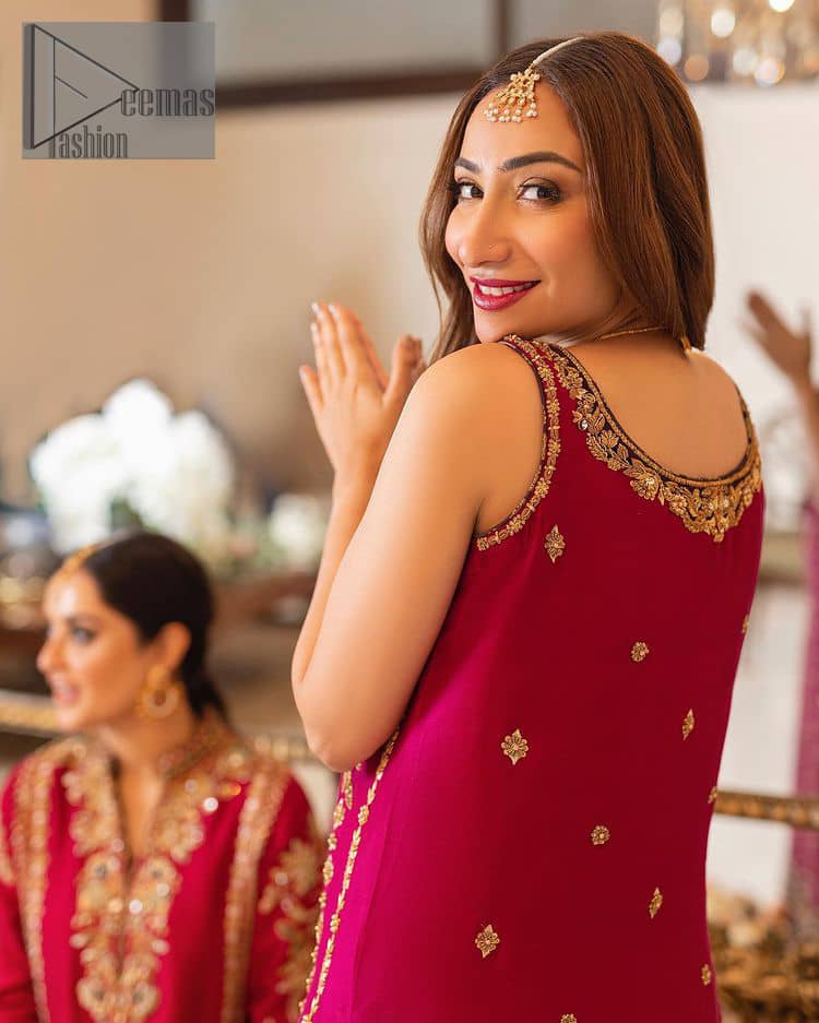 The golden pasting on a glamorous magenta canvas. The beautiful attire is presented that begins with a magenta long shirt which is attractively furnished with golden embroidery. It is spotlighted with tilla, dabka, kora and zardozi to make your event blazing and astonishing. In addition to this, it is attractively featured with a round neckline and sleeveless style. The following magenta long shirt is paired up with purple trousers that's border is again embellished with golden embroidery that gives a unique piece of style in every function.