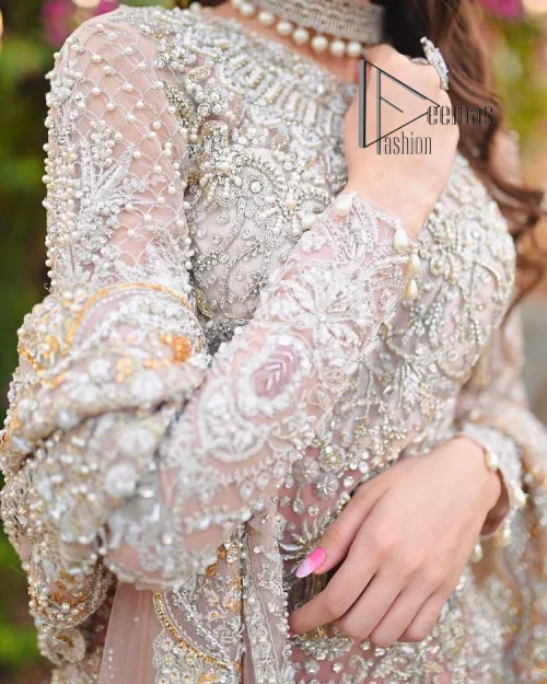 Introducing the mauve nikah outfit which begins with a short shirt that is meticulously and laboriously hand-rendered with silver embroidery