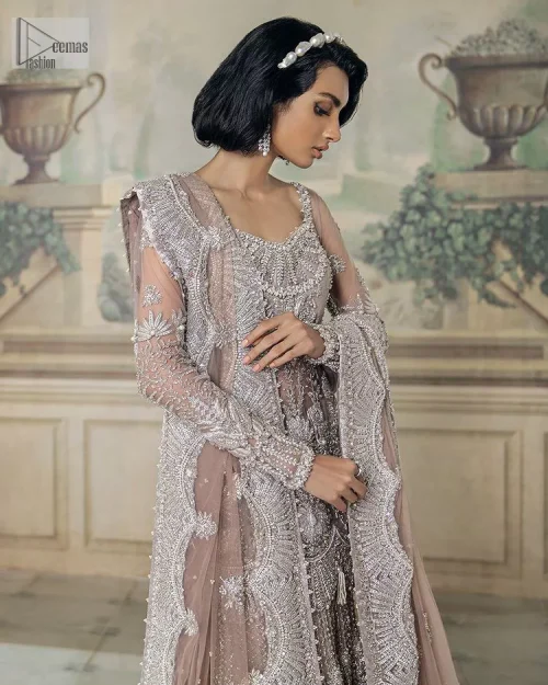 Luxurious canvas embodying grace and style! It is a well-crafted short shirt enhanced with silver embroidery accentuated with gleaming ornaments.