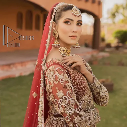 Love is in the air. A maroon blouse in maroon colour is hand-rendered in gold and is enhanced with naqshi,
