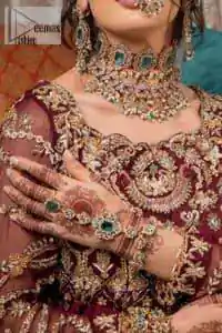 Take your style up a few notches in this elegant reception piece. A pure organza maroon fluffy lehnga is beautifully hand-rendered with golden embroidery and enhanced with  tilla, sitara, pearls, dabka and zardozi work. It is paired up with a blouse choli with tilla motifs on the full sleeves along with boat shape neckline to make your Big day astonishing and remarkable. The ivory organza dupatta has a four-sided embroidery adorned with pearls and Sitara and is framed with a scalloped style.