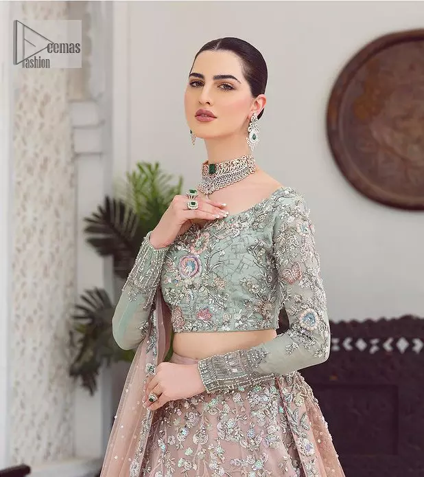 When you asked for it, we heard it. This sea green hued blouse has multiple colour embroidered details of tilla,dabka, kora, zari and sequin. It has a sweetheart neck and full sleeves style for gaining full attractiveness on your Nikah. The following blouse is organized with tea rose lehenga which is heavily embellished to make this masterpiece more aesthetic and cool.  Complete this article with a dupatta which is adorned with a four-sided embellished border. Further, it is enhanced with a sequin spray that you actually want for your big day.