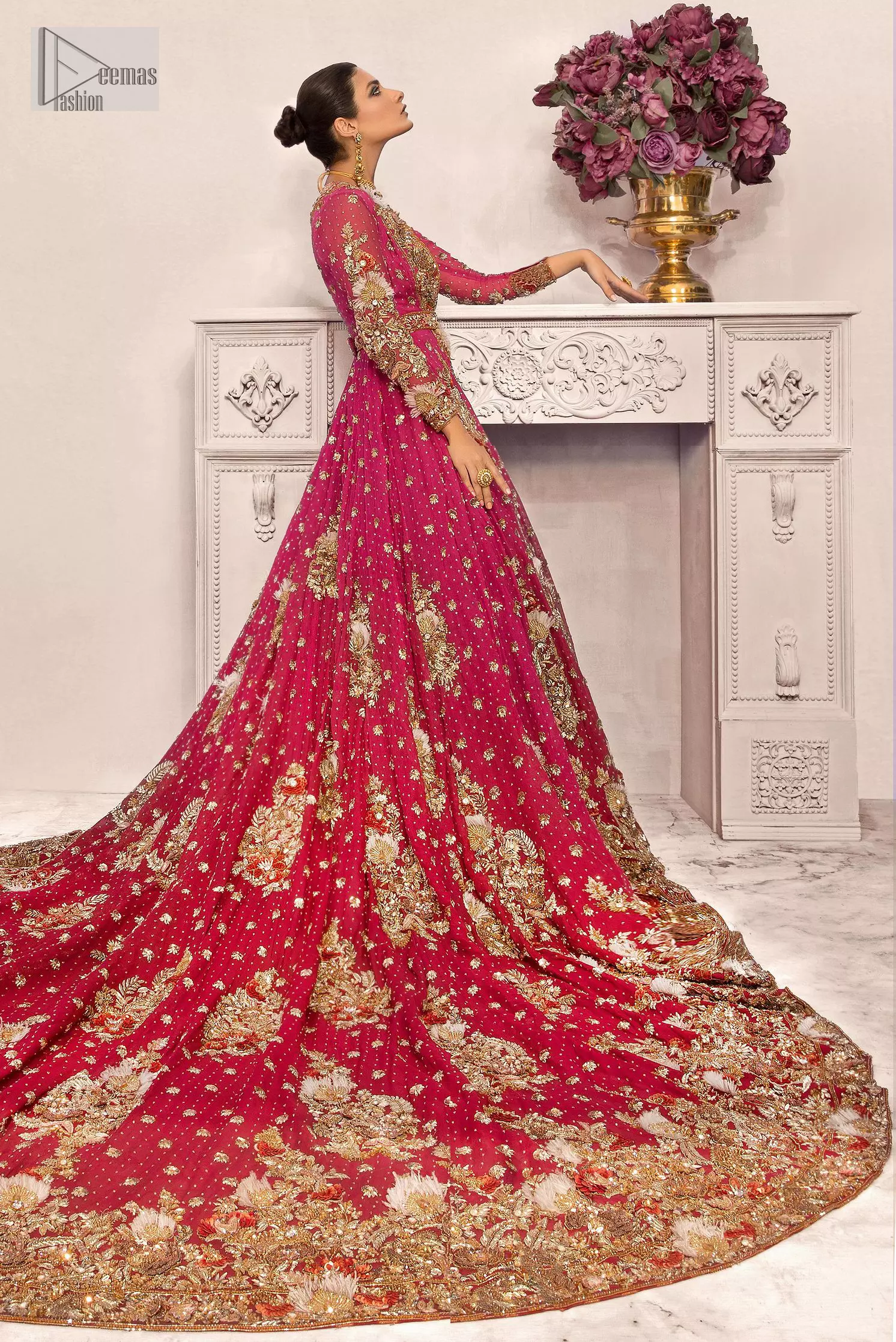 A maxi in a beautiful shade of shocking pink is deftly adorned with glowing tilla, dabka and pearls making this ensemble truly ethereal and incandescent. The following maxi is further enhanced with golden embroidery and laden with heavy floral motifs. The strapless neckline of the back train maxi also added more beauty to the outfit when comes with full sleeves. It is paired up with a plain can-can lehenga in the red colour to balance the reception fairy look of the bride. Finish this article with a dupatta which is ornamented with a four-sided embroidery and spray of tiny floral motifs and sequins all over for more romanticness and charmeness.