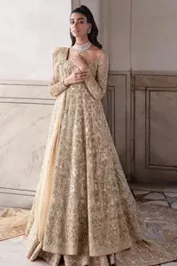 Ooze beauty and elegance in this simple yet amazing ensemble. This walima outfit in the off-white colour is a  magnificent look emblazoned with beautiful light golden embroidery which is further enhanced with tilla, dabka, kora, Kundan and the real magic of thread. The square neckline and full sleeves are unique in style and have classy look and perfect choice for the traditional bride. It is paired up with a lehenga which is adorned with beautiful embroidery. Father, the lehenga has a back-train to make this outfit lovely. Complete this with a dupatta framed with four-sided borders and sequins sprayed all over to add extra glam to this masterpiece.