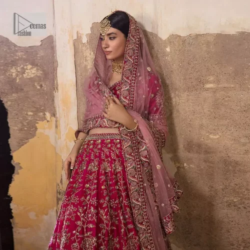 Blissful Pink! This ensemble is the epitome of grace. A shocking pink lehenga is heavily adorned with floral patterns. The