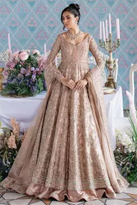 Make your Qabool Hai moment more memorable with this outfit by DeemasFashion. A dreamy statement of this dress proffers a soft pink hue with glamorous silver and golden embroidery.  It is further enhanced with tilla, dabka, kora, Kundan and the real magic of zardozi. V neckline enhances the overall glamour of this masterpiece. Intricate designs and fine details on the sleeves give a perfect finishing look to this maxi. The maxi is layered over a meticulously handcrafted lehnga which is bold enough to stand out in the crowd. Finish this article with a dupatta which is ornamented with four-sided borders and sequins sprayed all over which is a unique piece for your Nikah look. 
