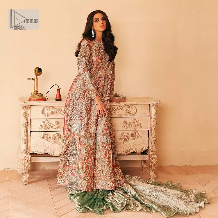 The latest elegant embroidered maxi in peach colour with magnificence embroidered work. The front open maxi is attractively laden with light golden embroidery to make this masterpiece unique and charming. Purely balanced raw silk maxi is presented with an ethereal blend of Resham, naqshi, kora, dabka and Mukesh carved with stones. Full Sleeves of the following maxi are also heavily embroidered. The round neckline gives it a magical look. It is coordinated with crushed lehenga in a pistachio green colour to create a ravishing Nikkah bride look. This crushed lehenga is paired with embroidered dupatta detailed with a splash of sequins and embroidered borders.