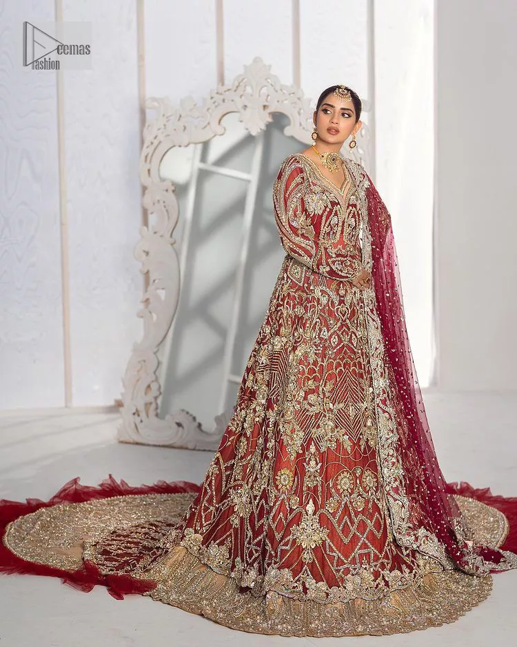 It’s all about looking stunning with a gorgeous Pakistani reception wear Red outfit. This beautiful red dress is designed with trendy full sleeves, following a back train maxi styled exquisitely with a floral pattern on sleeves. A sweeheart neckline makes your beauty bones prominent with a marvelous touch of light golden embroidery. It is paired up with light gold frilled lehenga which is enhance with tilla, dbka, kora, Kundan that is surely going to get you a lot of praise on your Big day. Giving it a final touch with dupatta, framed with a four sided borders and sequins sprayed all over to serve you with extraordinary grace.