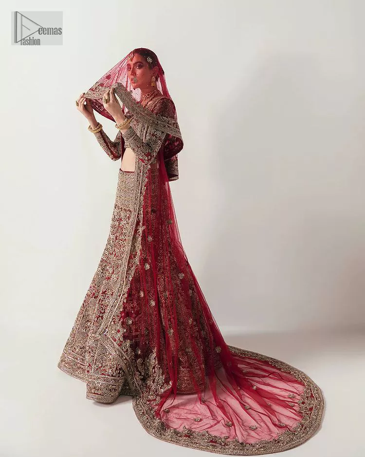 Walk with style at your reception and let the people follow! A stunning wine red blouse is embellished with intricate detailing and finished with light golden embroidery. It is further enhanced with the glorious amalgamation of zardozi, dabka, tilla, and elaborate stonework. Featuring a delicately embellished round neckline highlighted with zardozi detailing. The three-quarter sleeves of the following blouse give this outfit a unique look.  It is paired with a heavily embellished fish-cut lehenga with floral patterns that helps to sustain a traditional craft. Its dupatta is made from wine red net. Enveloping the sequin sprayed dupatta framed with a four-sided border that added divine pleasure to the entire article.
