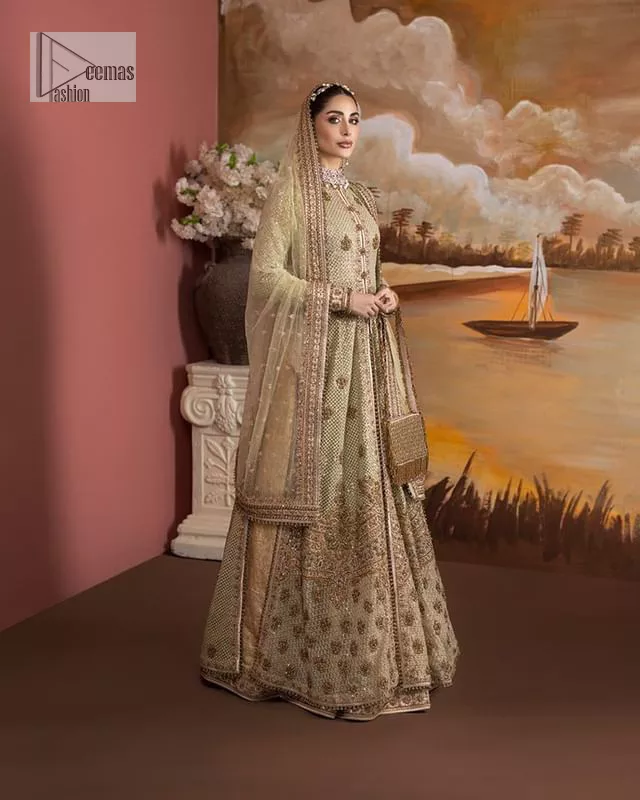 It's where words are not necessary – the outfit does all the talking! A beautiful designed pale green long shirt on an organza base has intricate details of gold, sequin, tilla, dabka, kora and tilla. A contrasting golden embroidery on the round neckline and on full sleeves is the star of the show. Each floral motif is so special, well-researched and strategically put together to create this spellbinding magic using the most gorgeous colour palette. It is paired with brocade lehenga to balance the whole outfit in a golden colour. Last but not least, the mehndi wear has a dupatta which is adorned with a four-sided embellished border in the most stunning way.