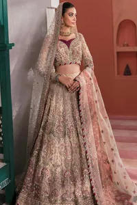 This elegantly poised nikah wear defines trendy fashion in its most acceptable form! The lehenga blouse is in the peach shade and hand-embellished with pearls, tilla, Resham, and dabka. Lavish designs on full sleeves and fine details on the sweetheart neckline make this breathtaking blouse your foremost priority for the wedding day. The blouse is enhanced with multiple colour embroidery to make your day more aesthetic. It is paired up with can-can lehenga that is adorned with heavy embroidery for perfection. A delicate dupatta is paired with this alluring Lehenga Choli that gives a magnificent look to the gorgeous bride that is adorned with four-sided borders and tiny floral motifs all over.