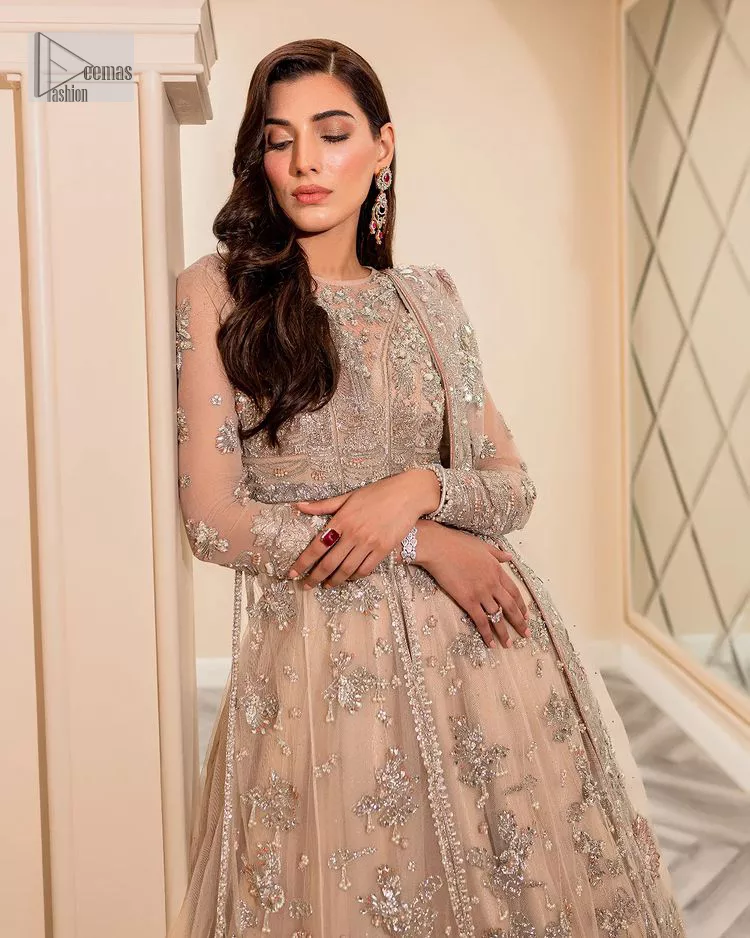 Get ready to lost in the world with floral and trendy designs. This dress is beautifully decorated with heavy embroidery. It is highlighted with kora, dabka, tilla, sequins and pearls. The shirt is enhanced with zardozi work on a jewel neckline. It comes with a plain lehenga in the same colour to balance the beautiful outfit. It is coordinated with a tissue dupatta which is sprinkled with sequins all over it. It is further furnished with a four-sided embellished border giving a perfectly glamorous look to the whole nikah wear. 