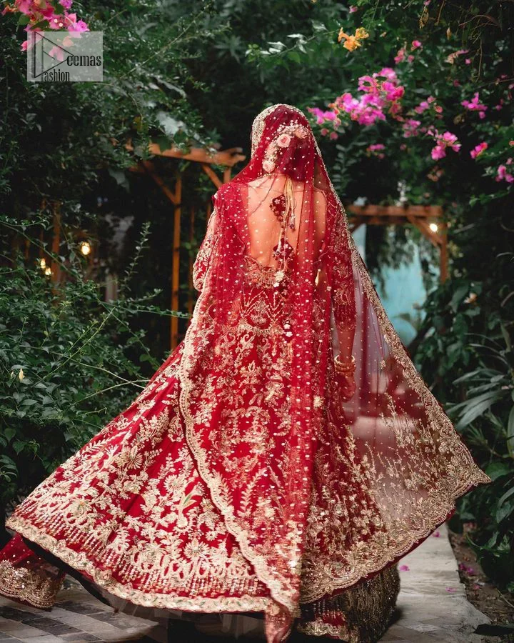 Classic deep red canvas with a bold twist of the pattern!  Bridal choli in the deep red shade is a beautiful attire to wear on the big day to have an elegant and classy look. This beautiful choli is heavily embellished with crystals, pearls, dabka,tilla, kora, Kundan, stones, and Zardozi giving a magnificent touch to the lehenga choli. The round neckline of the attractive blouse makes an outfit look more sophisticated. Further, the beautiful floral patterns on three-quarter sleeves make this outfit a must-have for your day. It is paired with a heavily embellished lehenga and is a stylish choice for the gorgeous Bride. Complete this romantic article with a dupatta framed with four-sided embellished borders and sequins sprayed all over.