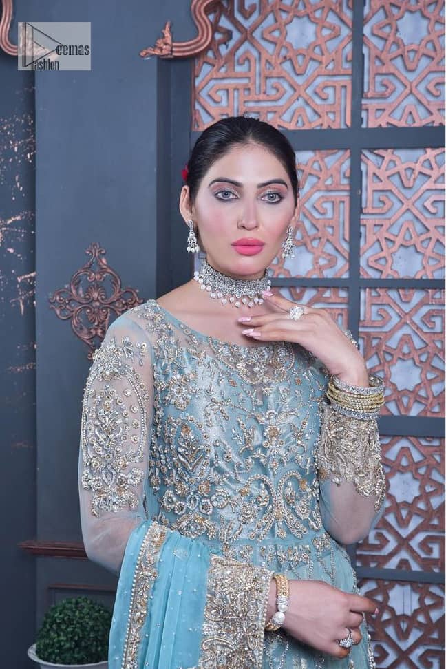 Bright colours are always a yes for a walima outfit. The embellished light blue maxi lehenga is an epitome of elegance and royalty that wins everyone's hearts at the very first glance with its charm and elegance. Hand-crafted details of golden and silver work on the maxi which is prominent with tilla, dabka, Kora, Kundan and the real magic of Zardozi give a glamorous touch to this masterpiece. The round neckline of the following maxi is the epitome of elegance. Further, the full sleeves are also decored with floral motifs. It is paired with a lehenga to balance the outfit details. Complete this outfit with a dupatta framed with four-sided borders and sequins sprayed all over.