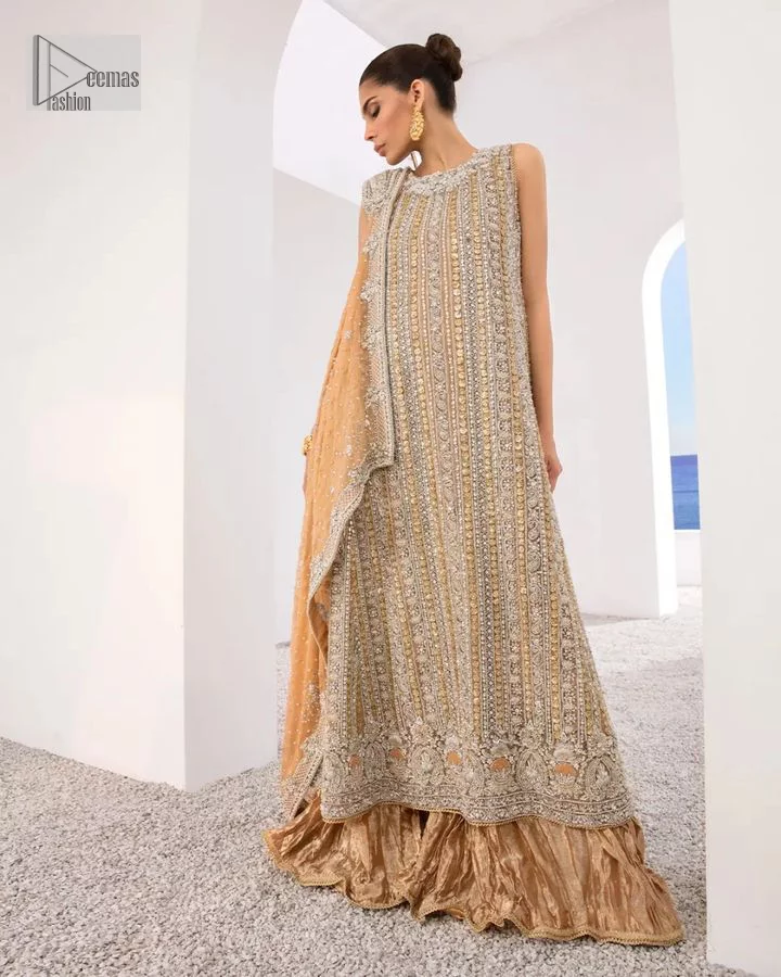 The silver and golden embroidery is the highlight of the party outfit! Keep it dreamy and classic with DeemasFashion. The handsome light orange long shirt is gracefully embellished with silver and gold embroidery that gives you a head-turning appearance on the wedding day. The shirt is enhanced with tilla, dabka, kora, Kundan, and crystals. The round neckline of the shirt makes this glamorous attire an epitome of royalty and grace. It is paired up with crushed sharara to make this masterpiece unique.  A light orange dupatta has a sequin-sprayed surface with branching tiny floral motifs all over. The beautifully embellished border envelopes the dupatta.