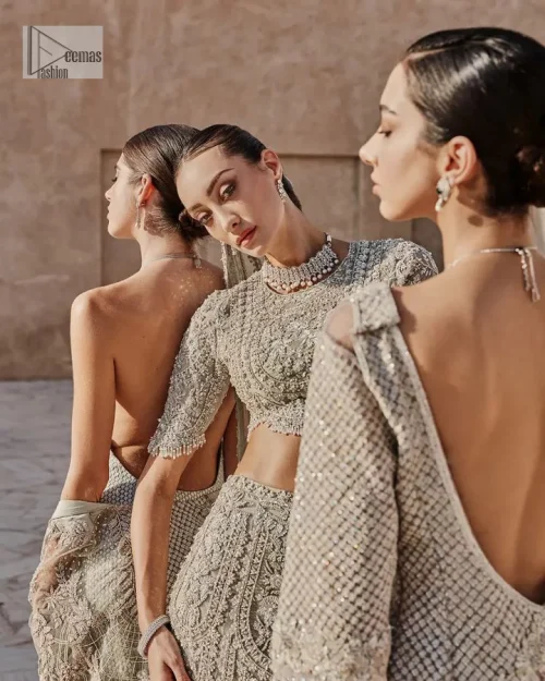 This fusion of floral embroidery is total fashion goodness for a walima outfit! A stunning teal grey organza choli embellished